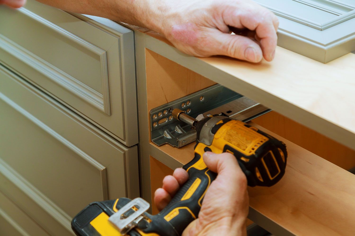 Kitchen Fitters Redditch at work screwing cabinet